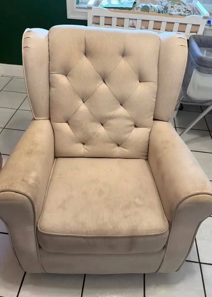 Beige buttoned nursing chair with grey-brown soiling on seat, arms and back