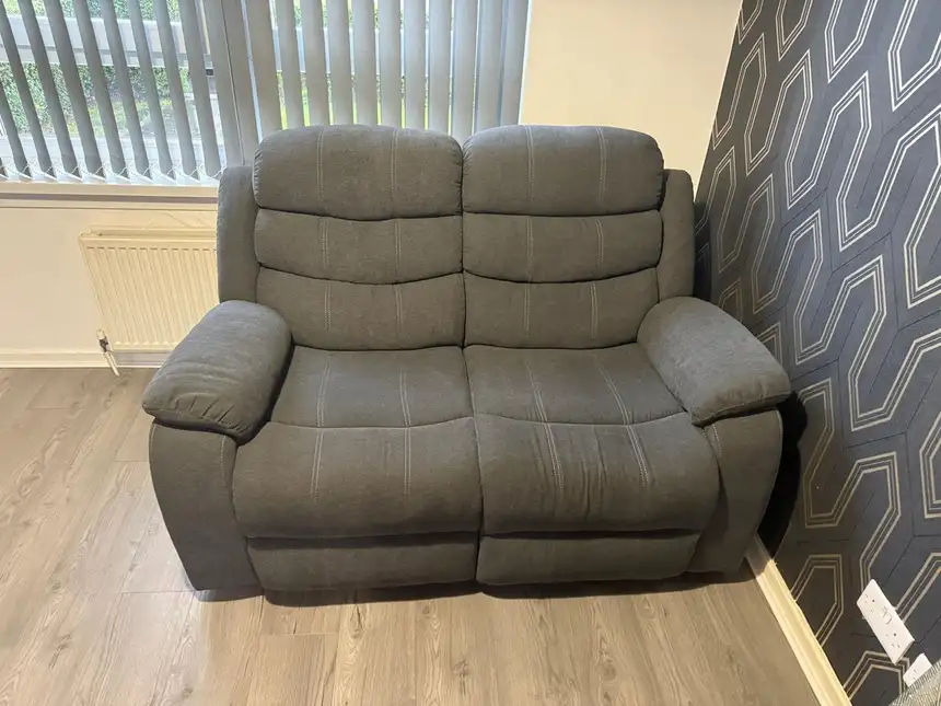 Grey fabric two-seater recliner sofa with even, lifted pile after cleaning
