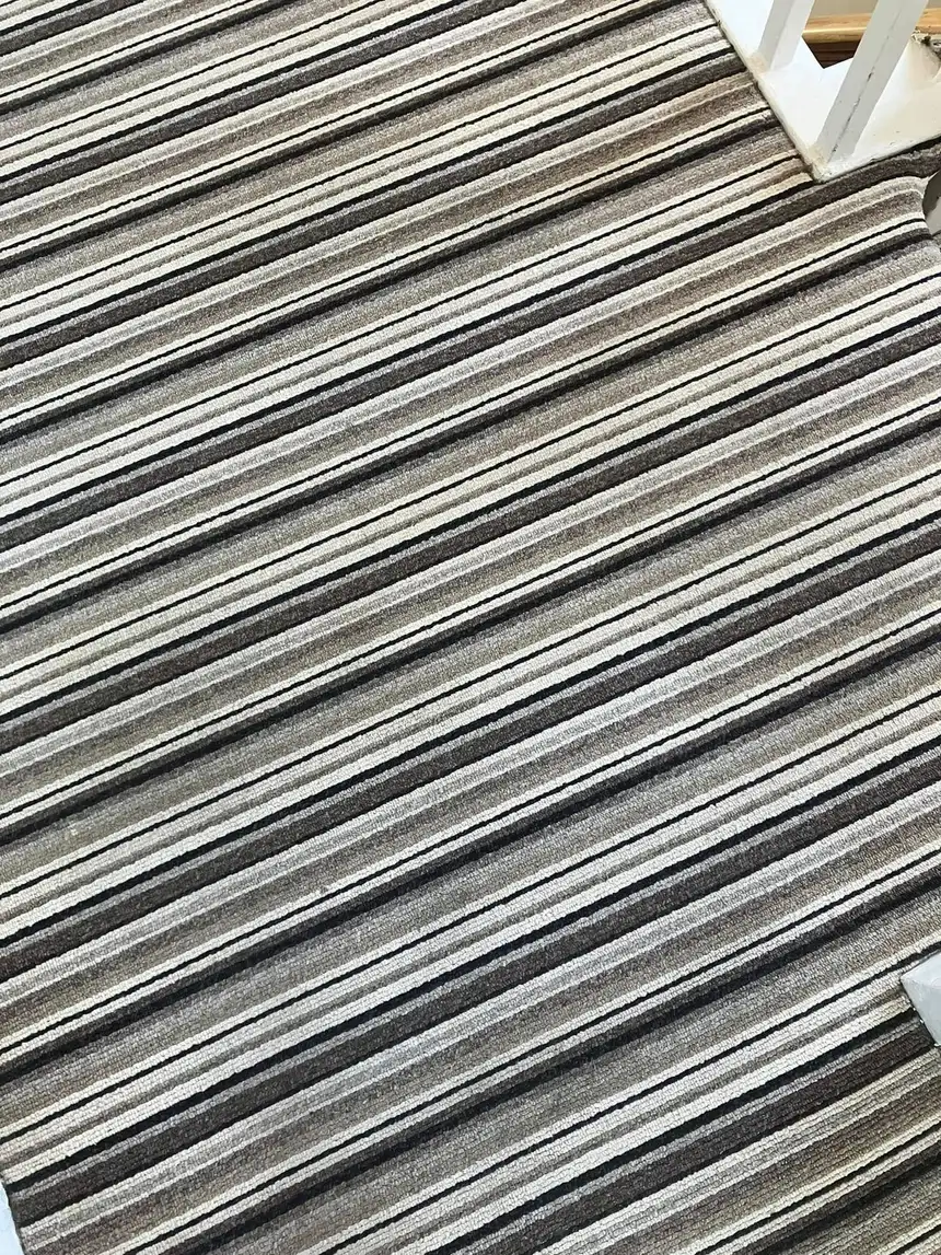 Striped brown and cream stair carpet looking uniform and mark-free after cleaning